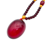 Red amber pendant with lens