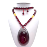 Red amber pendant with lens