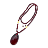 Red amber pendant with lens