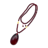 Red amber pendant with lens